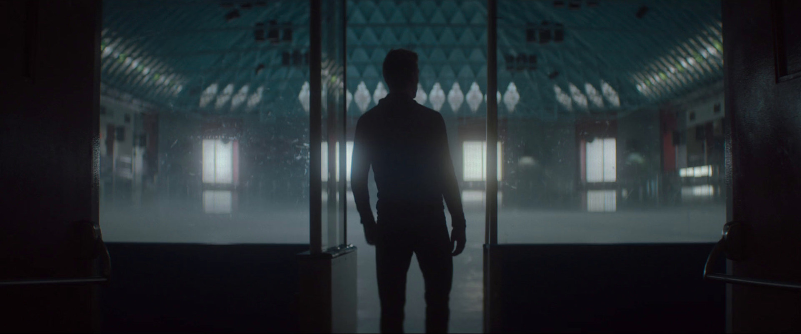 a man standing in front of a doorway in a building