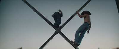 a couple of men standing on top of metal poles