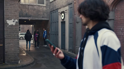 a group of people walking down a street next to a building