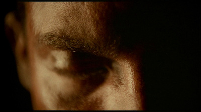 a close up of a person's eye with a dark background