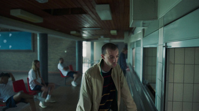 a man walking down an escalator in a building