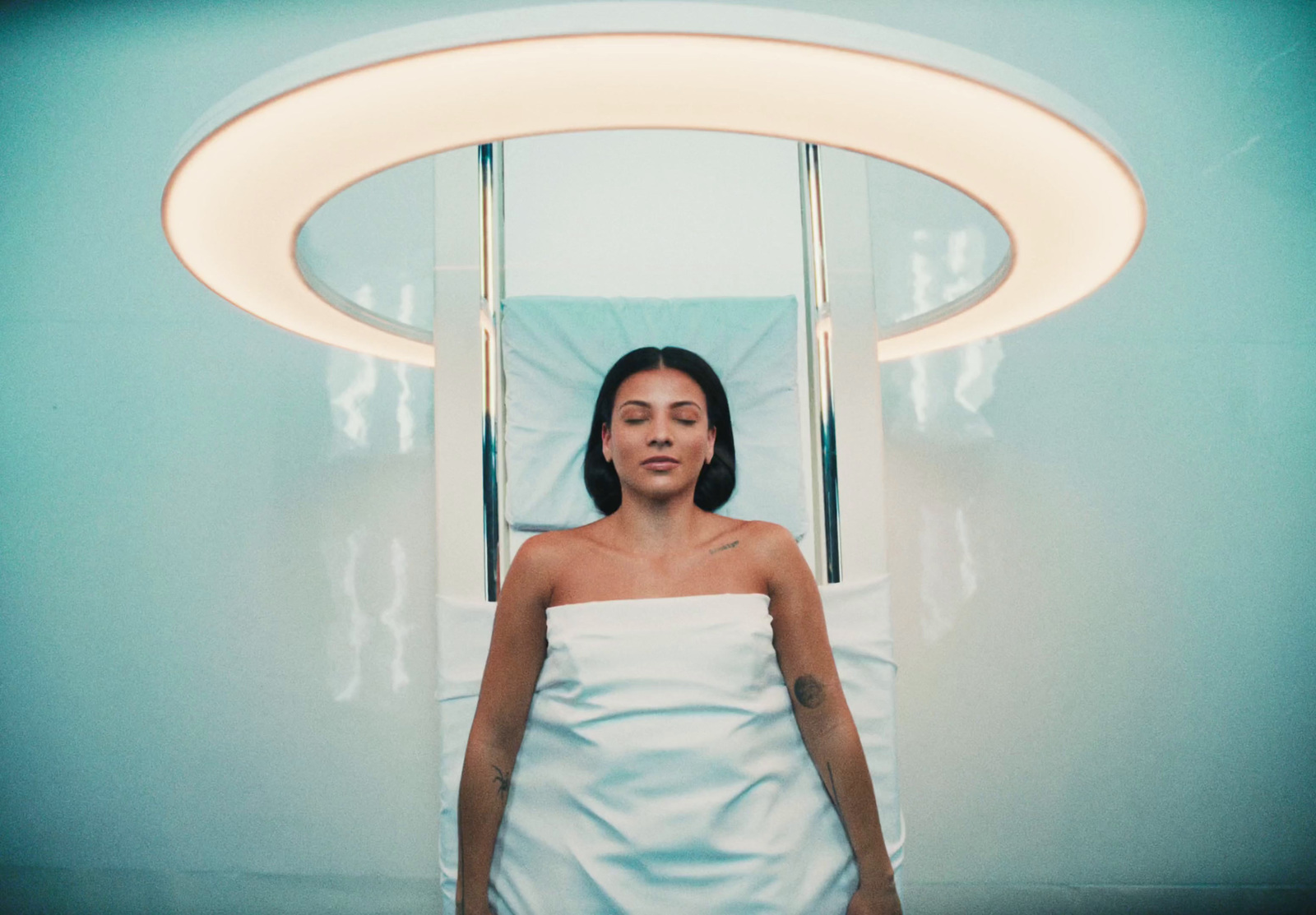 a woman in a white towel in a blue room