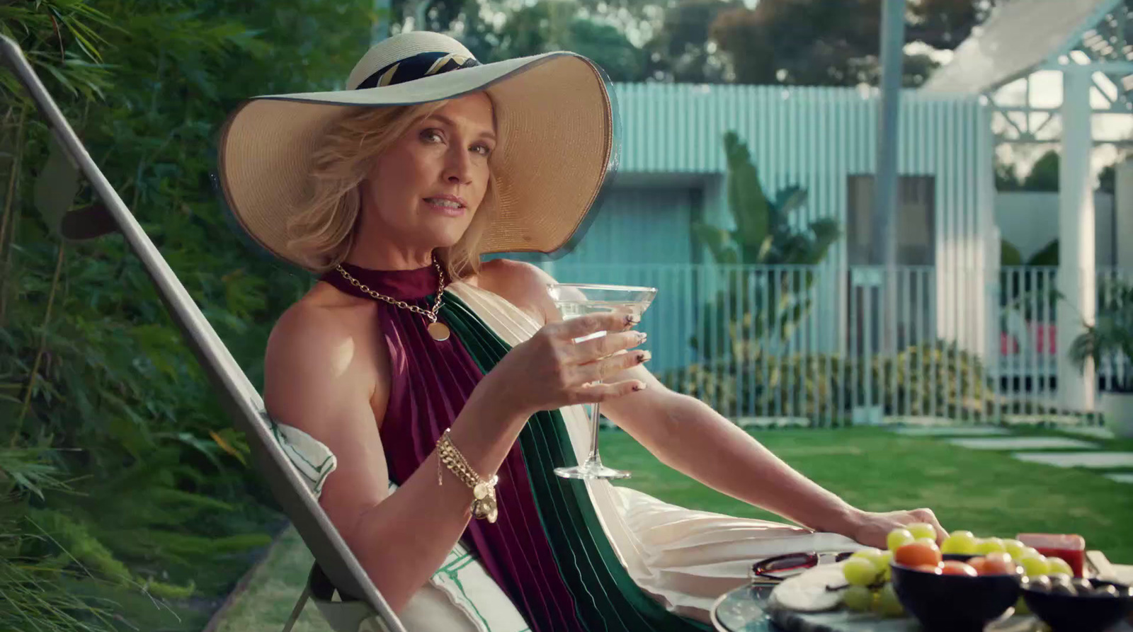 a woman sitting in a chair holding a glass of wine