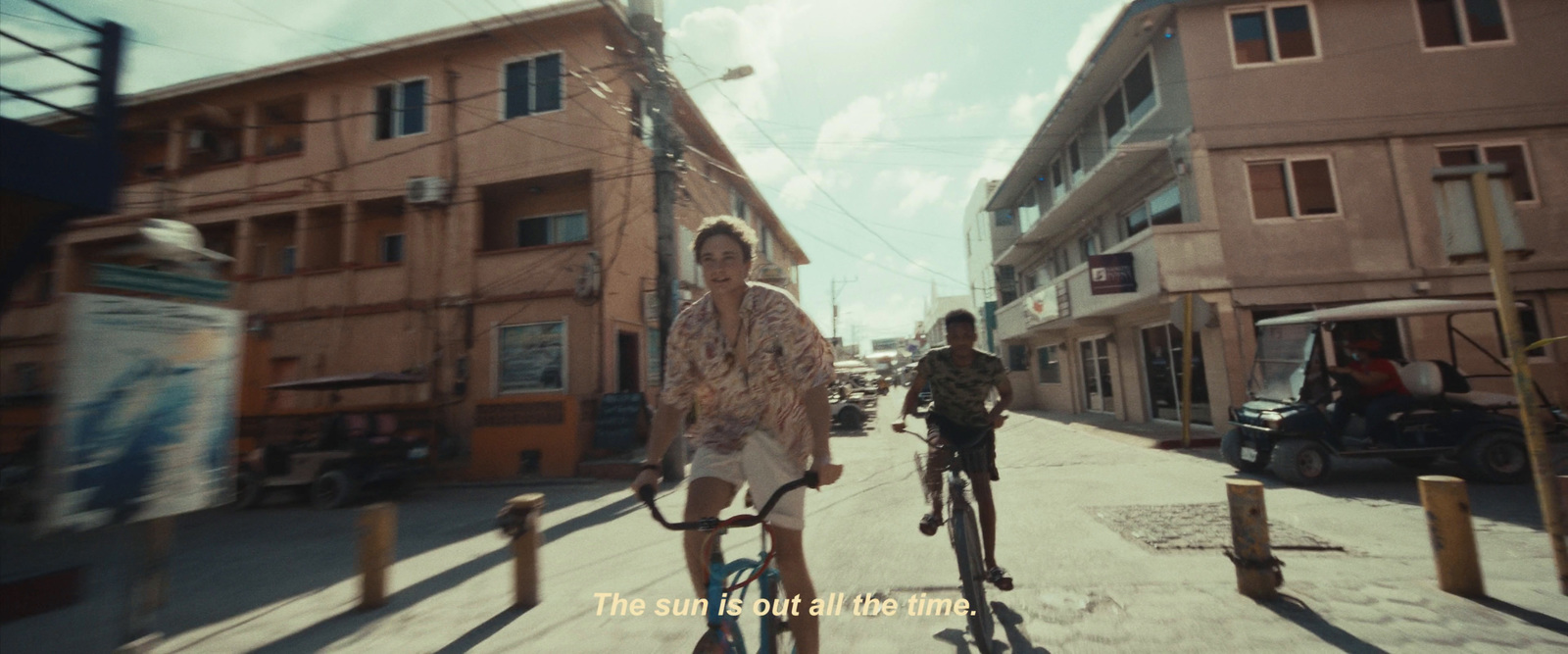 a couple of people riding bikes down a street