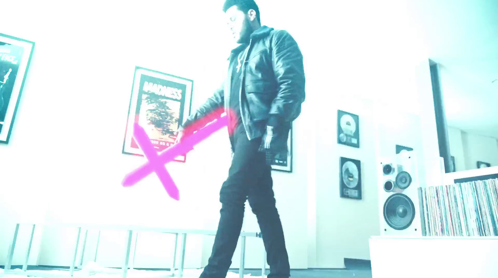 a man standing in a room holding a pink ribbon