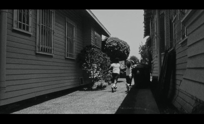 a black and white photo of people walking down a street