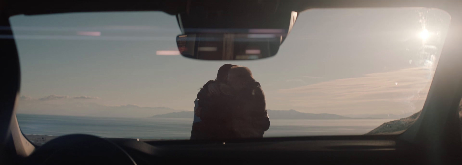 a person sitting in a car looking out the window