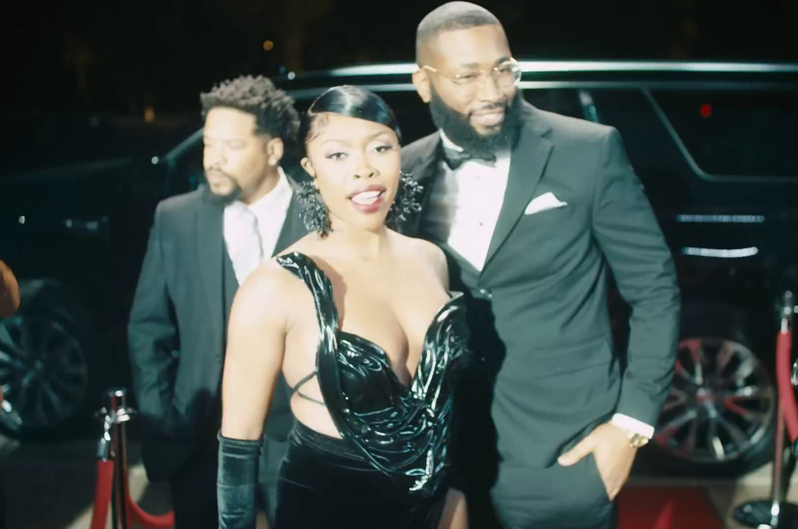 a man and a woman standing next to each other on a red carpet