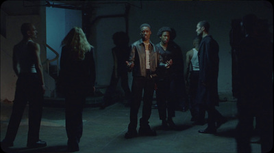 a group of people standing in a dark room