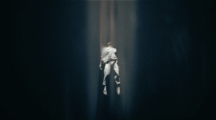 a blurry image of a person standing in a dark room