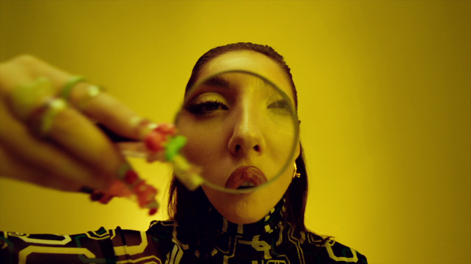 a woman holding a piece of fruit in front of her face