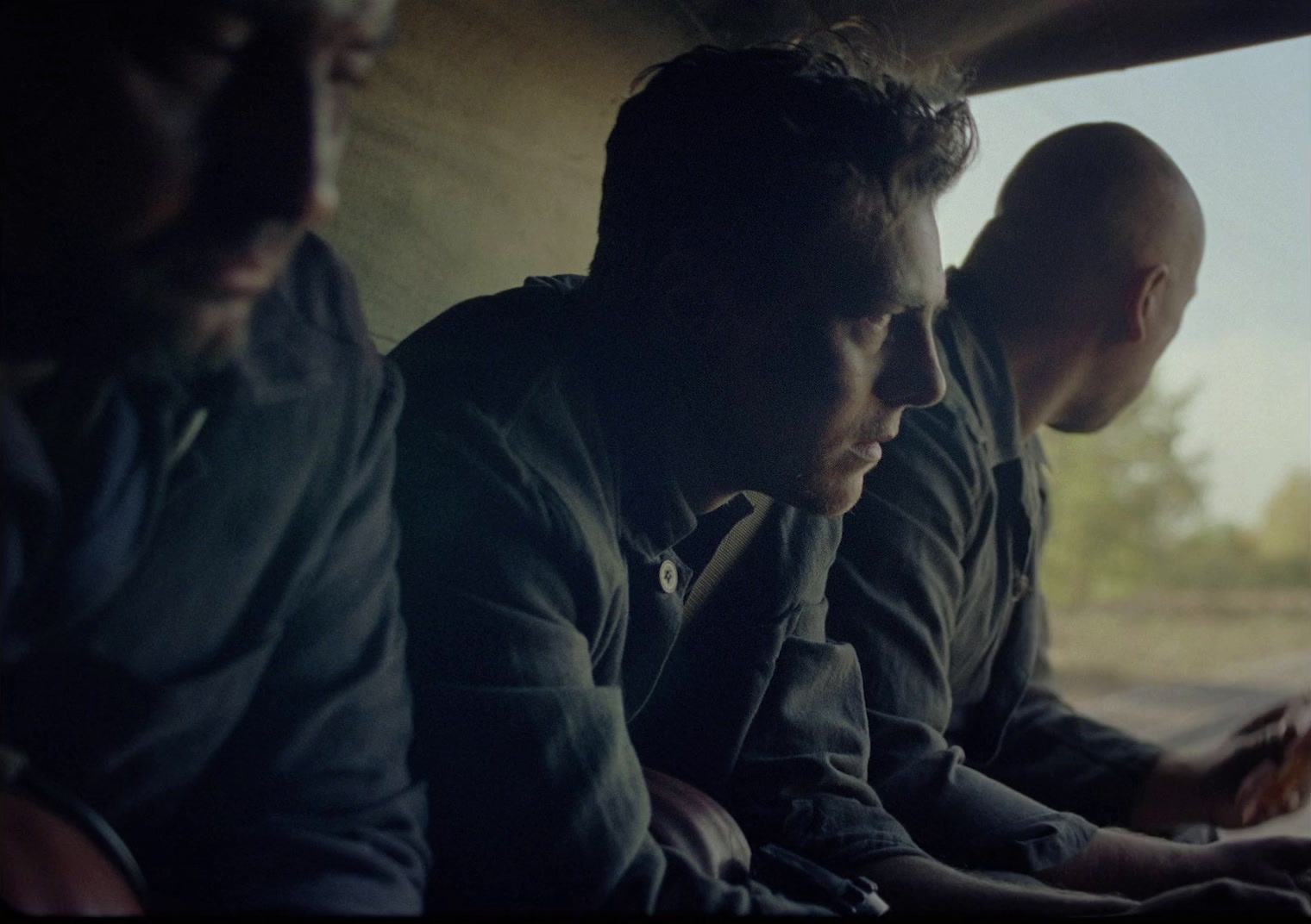 a group of men sitting next to each other