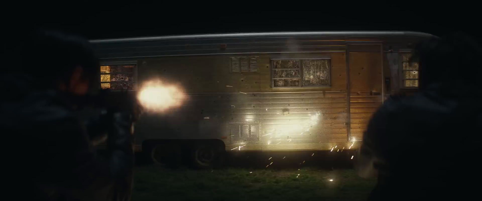 a group of people standing in front of a trailer