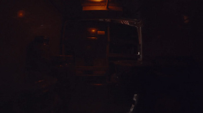 a bus driving down a street at night