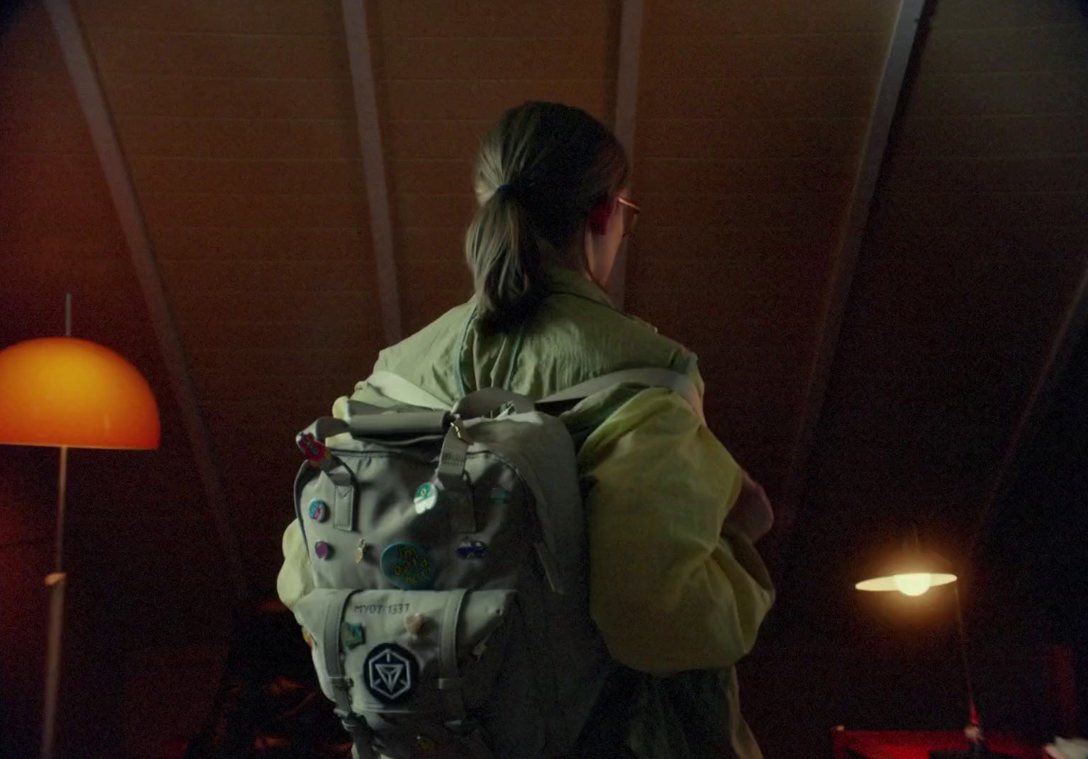 a woman with a backpack standing in a room