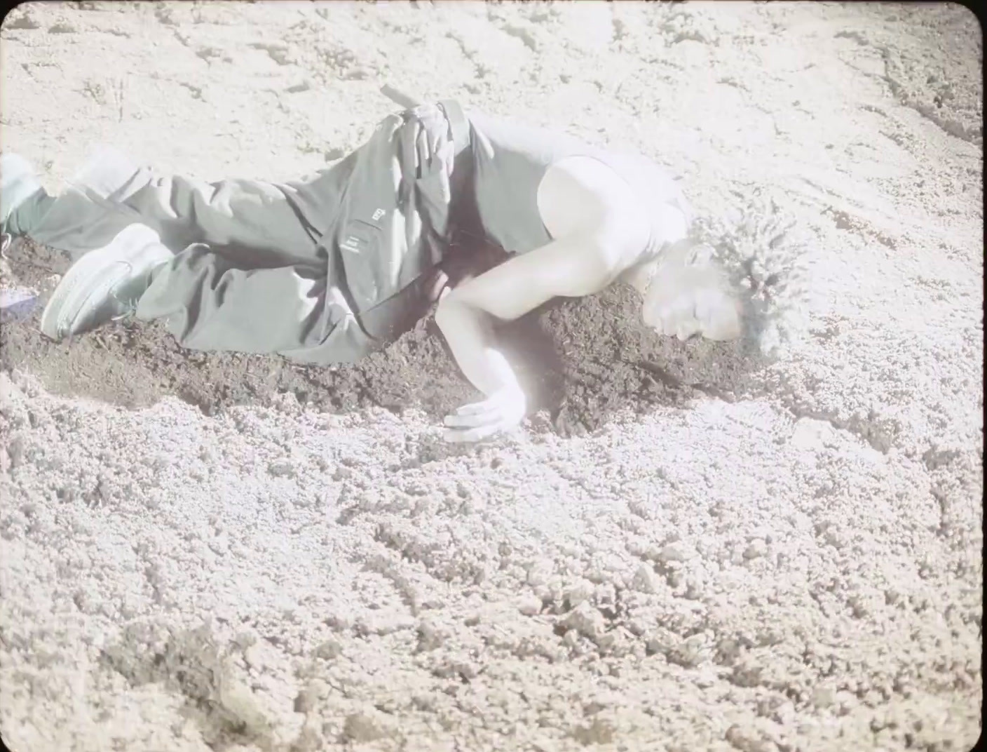 a person laying in the sand on a beach