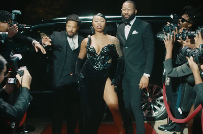 a group of people that are standing in front of a car