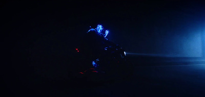 a person riding a motorcycle in the dark