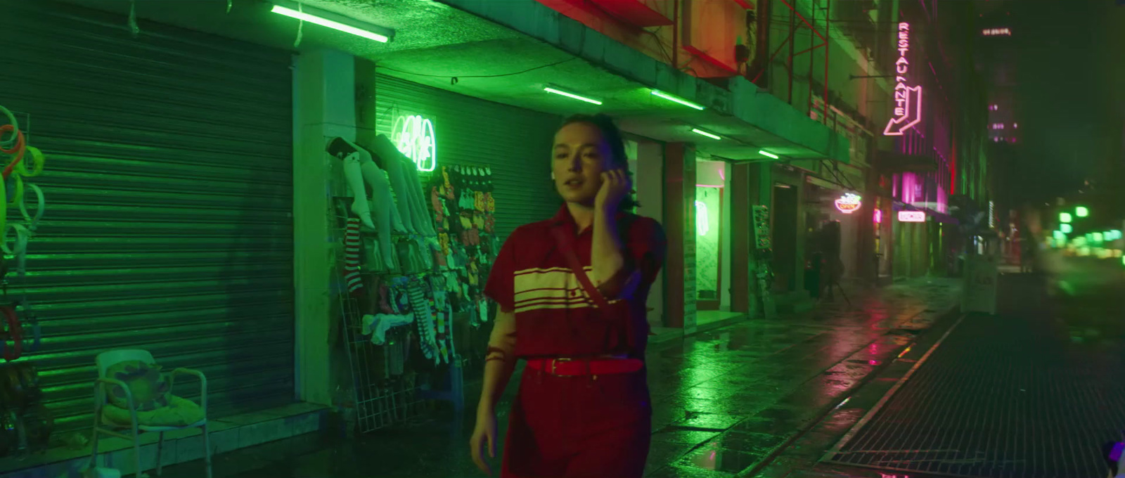 a woman standing in front of a neon sign