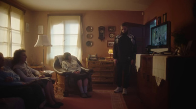 a man standing in a living room next to a group of people