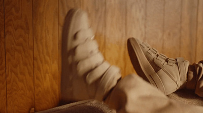 a pair of shoes sitting on top of a bed