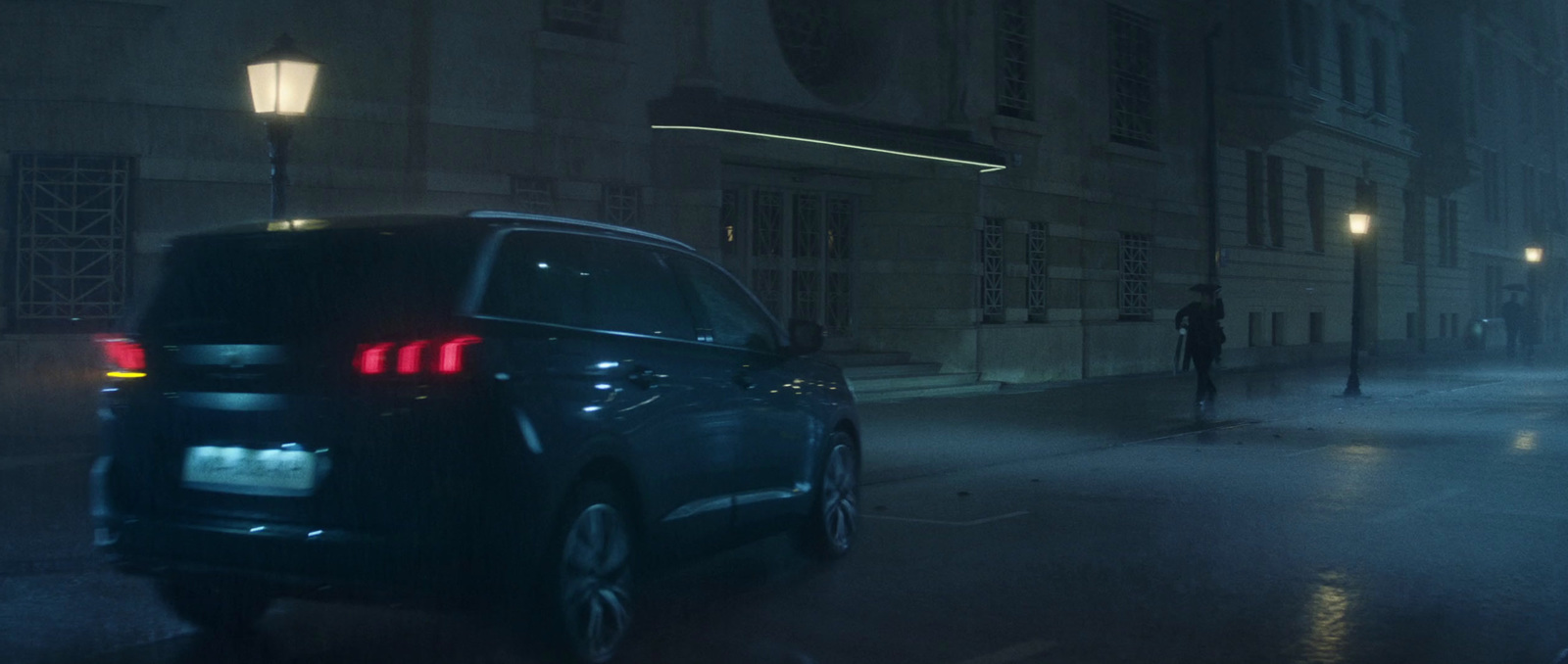 a car parked on the side of a street at night