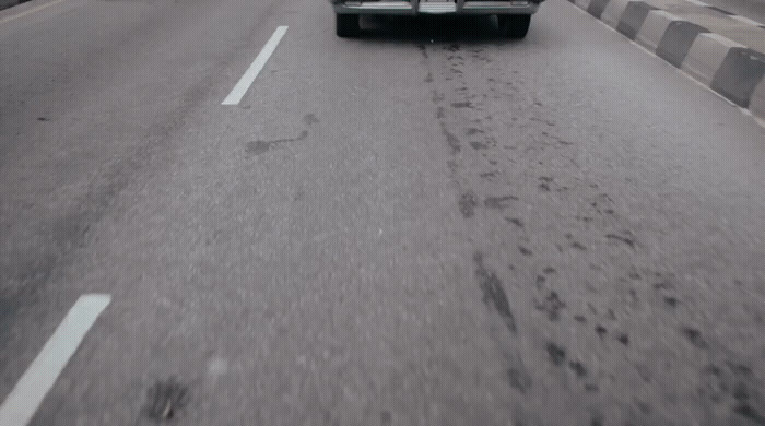 a truck is driving down a road in the rain