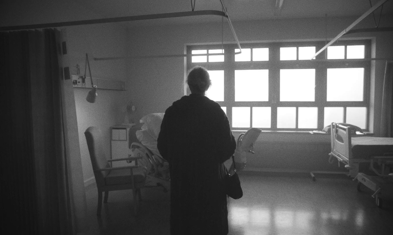 a black and white photo of a person in a hospital