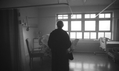 a black and white photo of a person in a hospital