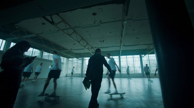 a group of people riding skateboards inside of a building