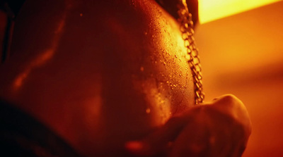 a close up of a person's back with a chain around their neck