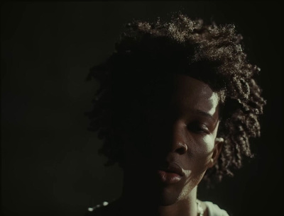 a close up of a person with curly hair