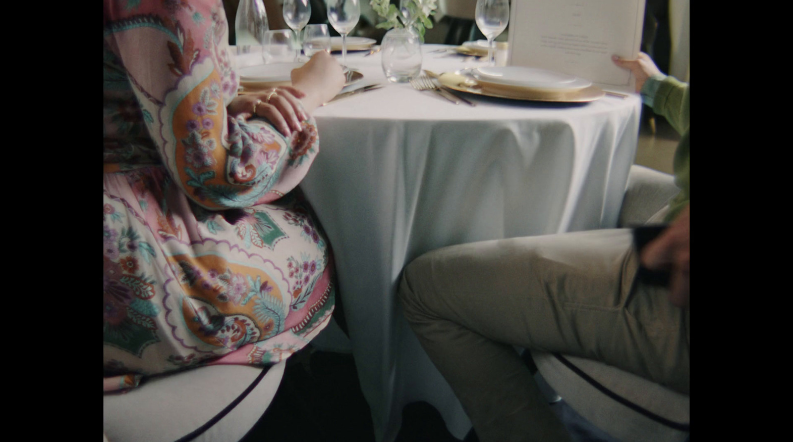 a woman sitting at a table with a plate of food