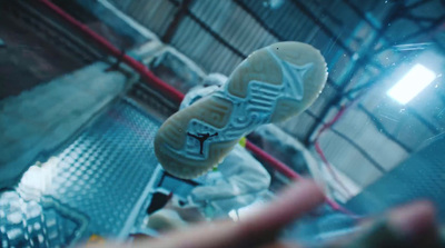 a pair of white shoes sitting on top of a metal rack