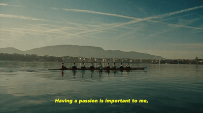 a group of people rowing a boat on a lake