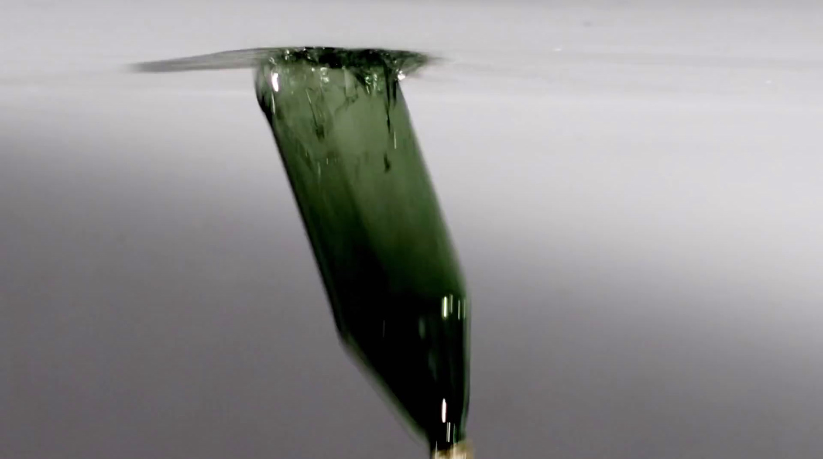 a drop of water that is falling into the water