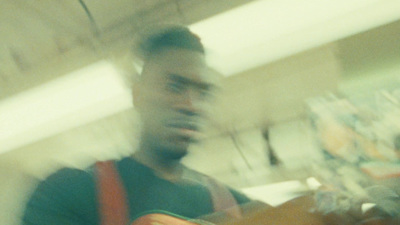 a blurry photo of a man holding a guitar