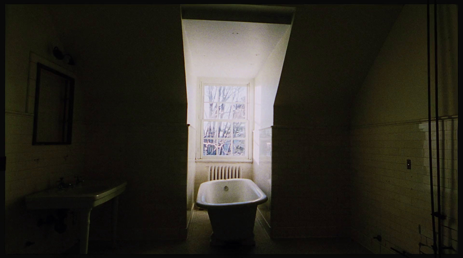 a bath tub sitting in a bathroom next to a window