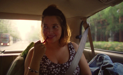 a woman sitting in the back seat of a car