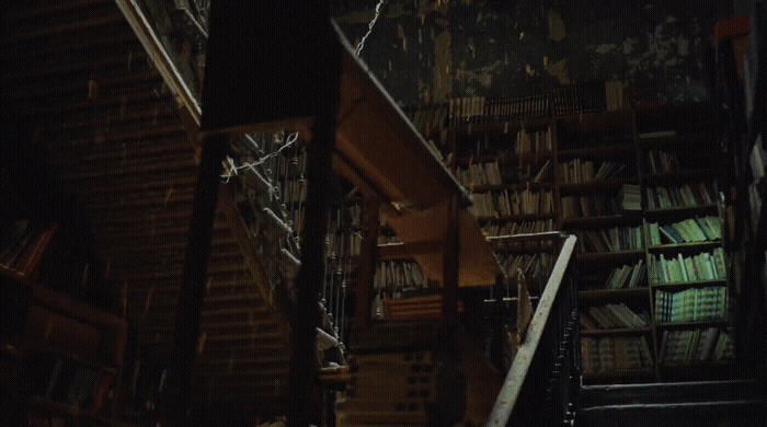 a staircase leading up to a bookshelf filled with books