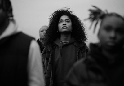 a black and white photo of a woman looking up