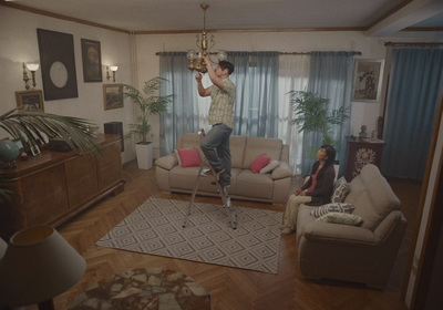 a man standing on a chair in a living room