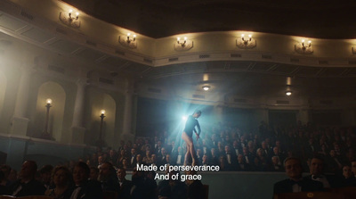 a person standing on a stage in front of a crowd