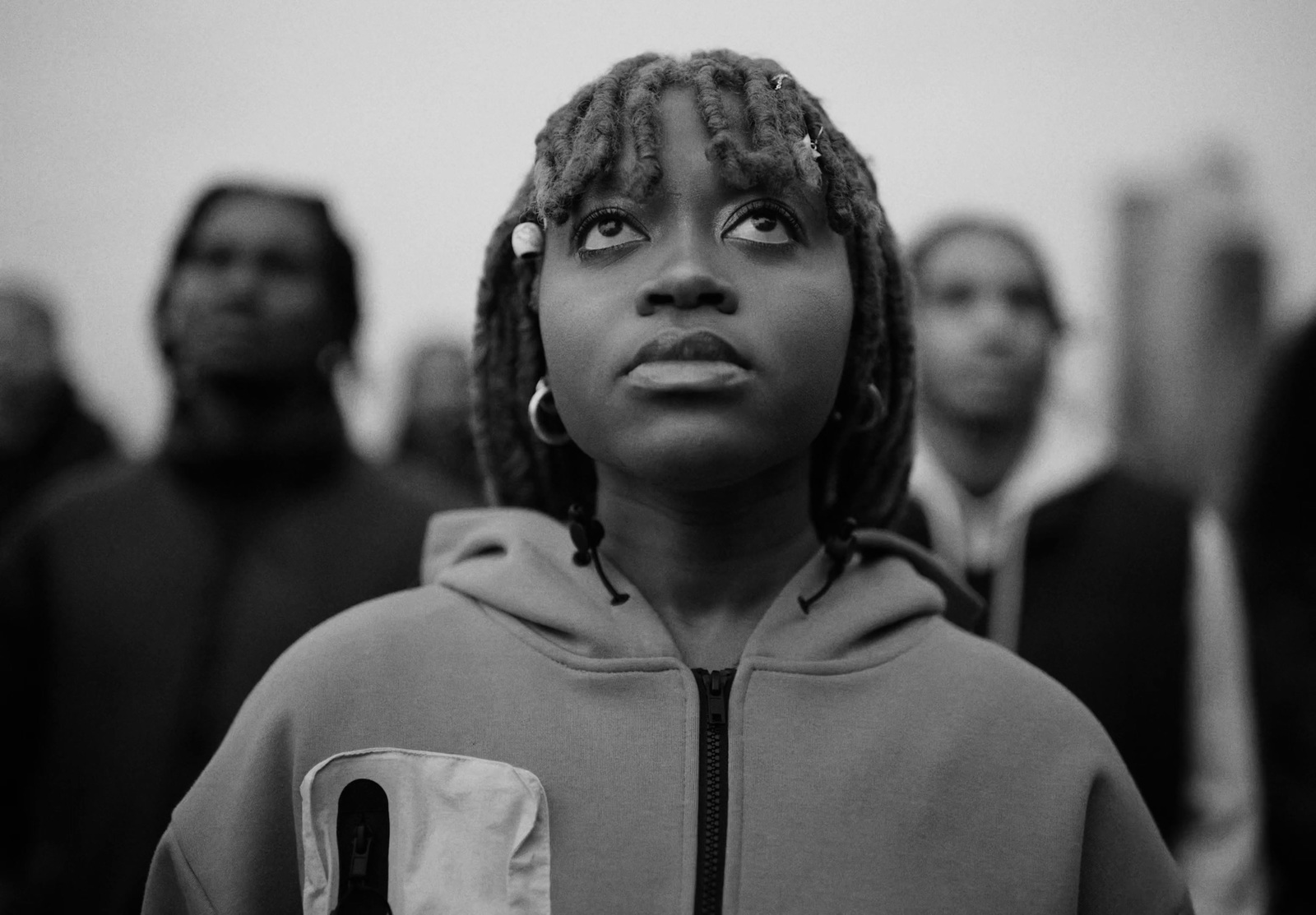 a black and white photo of a woman with dreadlocks