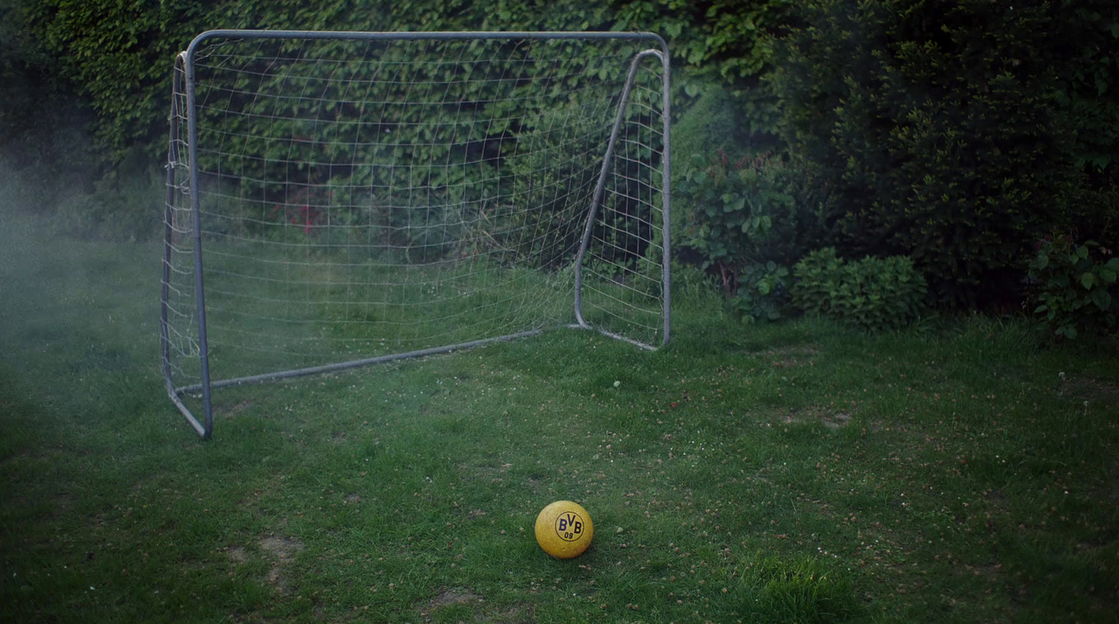 a soccer ball sitting in front of a soccer goal