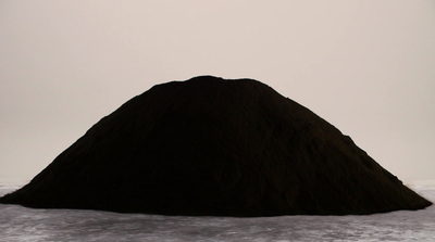 a large mound of dirt sitting on top of a snow covered ground