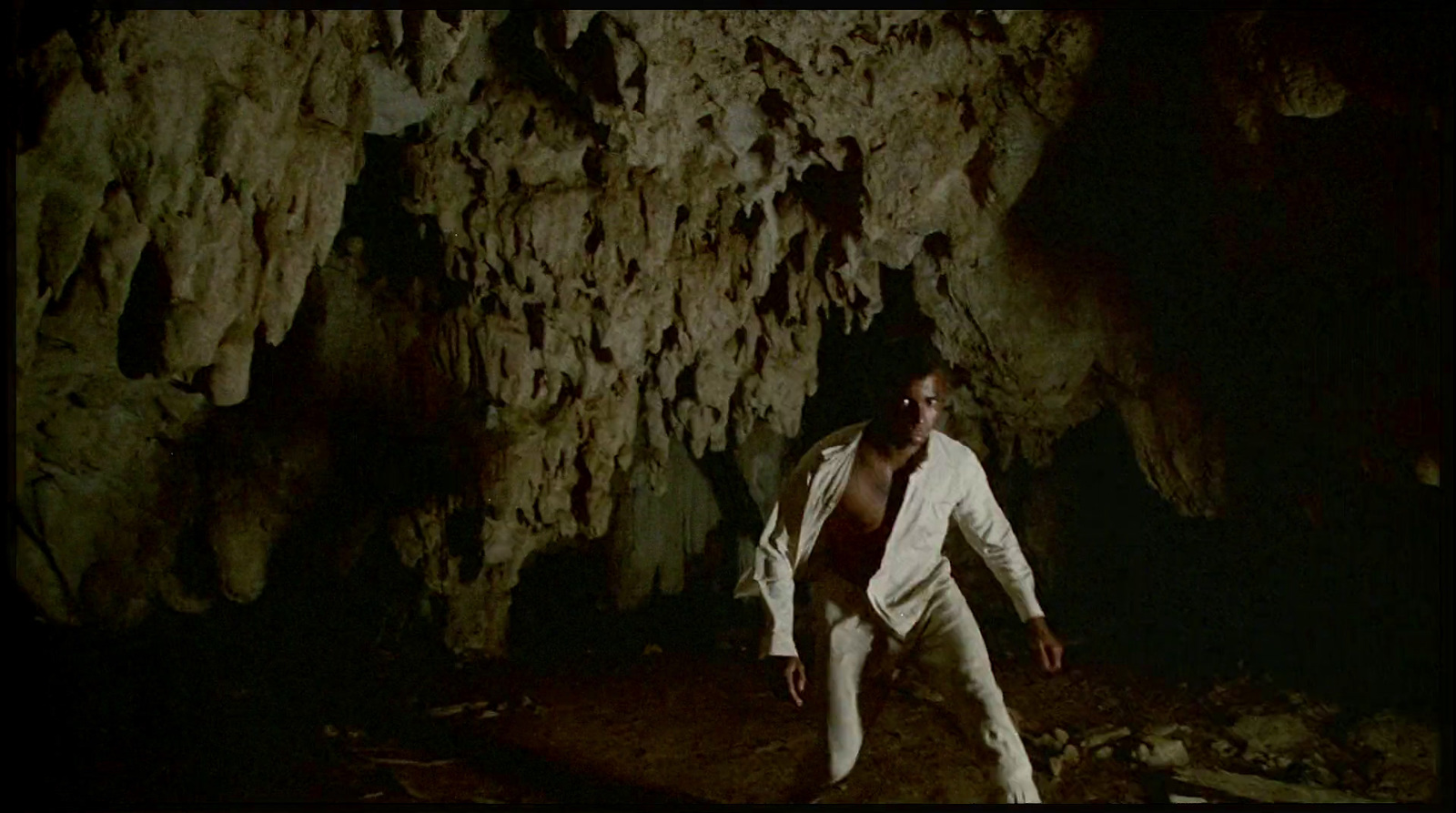 a man standing in front of a cave