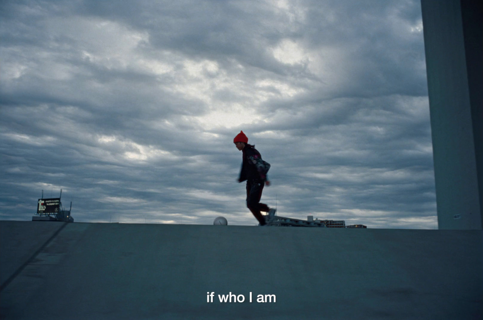 a person with a red hat is skateboarding