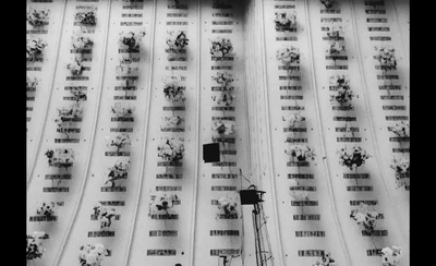 a black and white photo of people standing in front of a wall