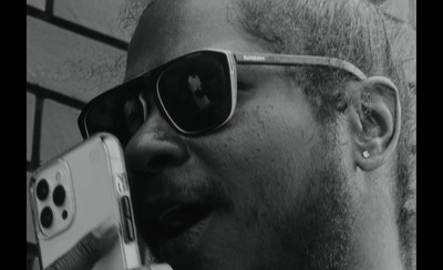 a man with sunglasses talking on a cell phone